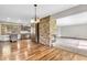 Open-concept living area featuring a stone fireplace, hardwood floors, and modern lighting at 7380 N State Road 267, Brownsburg, IN 46112