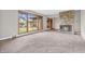 Open living room featuring a stone fireplace, new carpet, and large windows at 7380 N State Road 267, Brownsburg, IN 46112