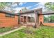 View of brick home's sunroom addition leading to the backyard and lawn at 7380 N State Road 267, Brownsburg, IN 46112