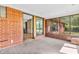 Bright sunroom with brick accent wall, tiled floors, and large windows offering backyard views at 7380 N State Road 267, Brownsburg, IN 46112
