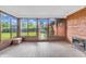Sunroom with tiled floors, backyard views, and vintage coal burning heater at 7380 N State Road 267, Brownsburg, IN 46112