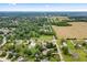 Overhead shot of a green residential area near cultivated fields, showing orderly streets and classic suburban houses at 7426 N Carroll Rd, Indianapolis, IN 46236