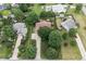 Aerial view of a home showcasing its large yard, mature trees, and proximity to other houses at 7426 N Carroll Rd, Indianapolis, IN 46236