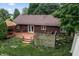 Aerial view showcases a backyard featuring a wooden deck and lush greenery, providing a serene and private outdoor space at 7426 N Carroll Rd, Indianapolis, IN 46236
