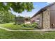 Backyard features a gazebo, landscaped garden, and exterior of the home with stone accents at 7426 N Carroll Rd, Indianapolis, IN 46236