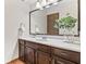 Bathroom featuring a vanity with dark cabinets, a vessel sink and a framed mirror at 7426 N Carroll Rd, Indianapolis, IN 46236