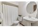 Bright bathroom with pedestal sink, toilet, and white shower curtain at 7426 N Carroll Rd, Indianapolis, IN 46236