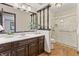 Bathroom featuring a vanity with dark cabinets, a vessel sink and a glass-enclosed shower at 7426 N Carroll Rd, Indianapolis, IN 46236