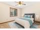 A comfortably furnished bedroom with a large window and modern ceiling fan at 7426 N Carroll Rd, Indianapolis, IN 46236