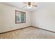 Bedroom featuring a window and ceiling fan with tan carpet at 7426 N Carroll Rd, Indianapolis, IN 46236