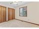 Bedroom with carpet, window and closet with wood door at 7426 N Carroll Rd, Indianapolis, IN 46236