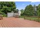 Wooden deck leading to a spacious backyard with lush lawn and mature trees, creating a serene outdoor space at 7426 N Carroll Rd, Indianapolis, IN 46236