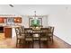 Open dining area next to a kitchen featuring a wooden table with chairs and a view to the backyard at 7426 N Carroll Rd, Indianapolis, IN 46236