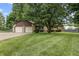 Charming home with a two-car garage, stone accents, and a well-maintained lawn at 7426 N Carroll Rd, Indianapolis, IN 46236