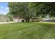 Charming home with a two-car garage, stone accents, and a lush front lawn at 7426 N Carroll Rd, Indianapolis, IN 46236