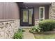 Inviting front entrance features a stone accent wall and well-maintained landscaping, creating a warm and welcoming atmosphere at 7426 N Carroll Rd, Indianapolis, IN 46236