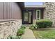 Charming front entrance with stone accents and manicured landscaping, enhancing the home's curb appeal at 7426 N Carroll Rd, Indianapolis, IN 46236