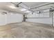A large garage with storage cabinets and a clean concrete floor at 7426 N Carroll Rd, Indianapolis, IN 46236