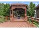 Charming gazebo featuring a built-in fire pit and seating, surrounded by a spacious wooden deck at 7426 N Carroll Rd, Indianapolis, IN 46236