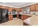 A kitchen showcases wood cabinets and stainless steel appliances at 7426 N Carroll Rd, Indianapolis, IN 46236