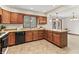 A corner kitchen features wood cabinets and stainless steel appliances at 7426 N Carroll Rd, Indianapolis, IN 46236