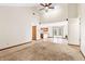 Open-concept living room with dining and kitchen views, high ceilings, and neutral carpet at 7426 N Carroll Rd, Indianapolis, IN 46236