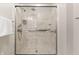Updated shower stall with marble-look shower surround, glass doors and modern shower head and controls at 7426 N Carroll Rd, Indianapolis, IN 46236