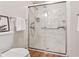 Updated shower stall with marble-look shower surround, glass doors and modern shower head and controls at 7426 N Carroll Rd, Indianapolis, IN 46236