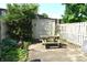 Backyard with a picnic table, a shed, a fence, and lush greenery at 7443 Country Brook Dr, Indianapolis, IN 46260