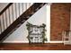 Basement featuring modern stairs, brick wall, and neutral color scheme at 7443 Country Brook Dr, Indianapolis, IN 46260