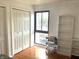 Bedroom featuring hardwood floors, a window with neighborhood view, and a double closet at 7443 Country Brook Dr, Indianapolis, IN 46260