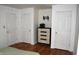 Bedroom with three doors, hard wood floors, and chest at 7443 Country Brook Dr, Indianapolis, IN 46260
