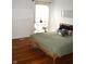 Bright bedroom with hardwood floors and a large window at 7443 Country Brook Dr, Indianapolis, IN 46260