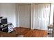 Bedroom featuring hardwood floors and white closet doors, offering ample storage space at 7443 Country Brook Dr, Indianapolis, IN 46260