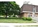 Exterior view of a townhome complex with well-manicured landscaping at 7443 Country Brook Dr, Indianapolis, IN 46260