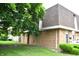 Brick exterior showcases a side view of a well-maintained property with a green lawn and landscape at 7443 Country Brook Dr, Indianapolis, IN 46260