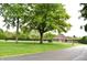 Exterior view of a well maintained lawn and community building at 7443 Country Brook Dr, Indianapolis, IN 46260
