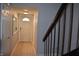 Hallway with neutral walls and a light-colored tile floor, leading to the front door at 7443 Country Brook Dr, Indianapolis, IN 46260