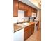 A functional kitchen featuring wood cabinets, white appliances, and laminate countertops at 7443 Country Brook Dr, Indianapolis, IN 46260