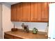 Kitchen counter with wood cabinets, offering ample storage and a functional space for meal preparation at 7443 Country Brook Dr, Indianapolis, IN 46260