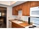 Functional kitchen with wood cabinets, white appliances, and laminate countertops at 7443 Country Brook Dr, Indianapolis, IN 46260