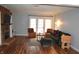 Cozy living room featuring a brick fireplace, hardwood floors, and a comfortable seating arrangement at 7443 Country Brook Dr, Indianapolis, IN 46260