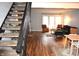 View of the living room with wood floors and a staircase with dark railings at 7443 Country Brook Dr, Indianapolis, IN 46260