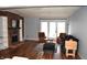 Inviting living room features a fireplace, hardwood floors, and a beautiful view of the backyard at 7443 Country Brook Dr, Indianapolis, IN 46260