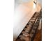 Carpeted staircase with black railing and light walls, illuminated by a window at 7443 Country Brook Dr, Indianapolis, IN 46260