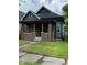 Charming bungalow with an inviting covered porch, brick supports, and green siding at 830 Villa Ave, Indianapolis, IN 46203