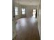 Open-concept living room with new flooring and bright, natural light from large windows at 830 Villa Ave, Indianapolis, IN 46203