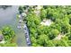 Panoramic aerial view of waterfront homes with private docks, surrounded by dense green trees and a community pool at 8331 Tequista Ct, Indianapolis, IN 46236