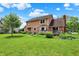 Exterior view of a home with a spacious backyard featuring mature trees at 8331 Tequista Ct, Indianapolis, IN 46236