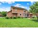 Backyard view of home featuring a deck, patio area, and lush green lawn at 8331 Tequista Ct, Indianapolis, IN 46236